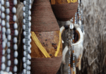 Close-up of traditional beaded gourd vessels.